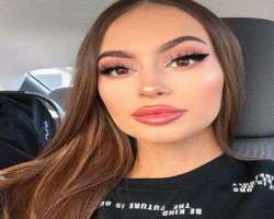 She has a piercing in her nose and is wearing a cute ring in her nose.